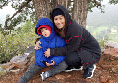 a person with a kid under a tree